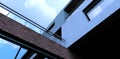 View from below on the facade of a traditional office building finished with decorative bricks and concrete. Panoramic reflective Royalty Free Stock Photo