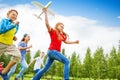 View from below of girl holding big airplane toy Royalty Free Stock Photo