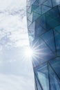 View from below of a glass corporate skyscraper illuminated by sunlight Royalty Free Stock Photo