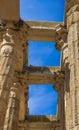 View from below of the granite row columns of the Roman Temple of Diana with a dove perched on its beams, under a clear blue Royalty Free Stock Photo
