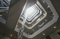 View from below of interior structure in metal and glass of an empty modern building without people