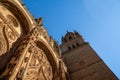 View from below looking up of the main door and tower with bas-reliefs of animals, beasts and chimeras of the Cathedral of the Royalty Free Stock Photo