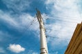 A view from below of a metal power transmission mast against the blue sky. Energy supply production Royalty Free Stock Photo