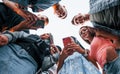 View from below. With phone. Group of young cheerful friends having fun together. Party outdoors Royalty Free Stock Photo