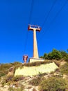 View from below of ski lift on Escape Mountain under blue sky. Constructions and engineering. Wiring and power lines for chair