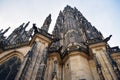 View from below on tall ancient the St. Vitus Cathedral with statues in Prague Royalty Free Stock Photo