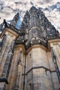 View from below on tall ancient the St. Vitus Cathedral with cloud sky in Prague Royalty Free Stock Photo