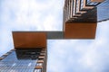 A view from below of tall office building towers connected at the top by a passage against the sky with clouds Royalty Free Stock Photo