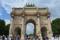 View from below to Arc de Triomphe du Carrousel and people walking