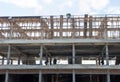 A view from below to the construction of a rowhouse building anchored.