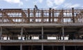 A view from below to the construction of a rowhouse building anchored.