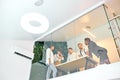 View from below on young team of diverse co-workers standing round table