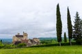 View of the Beynac Castle in the Dordogne Valley under an overcast expressive sky