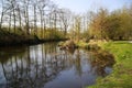 View beyond bare trees on river Schwalm in spring, Germany, BrÃÂ¼ggen Royalty Free Stock Photo