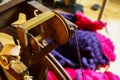 View beyond flyer of wooden old retro spinning wheel on knitted colorful purple pink blanket, ball of raw merino wool Royalty Free Stock Photo