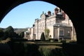 View of Biddulph Grange palace through a round window in the garden pagoda