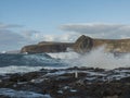 view of big breaking waves with foam splash and coastal cliffs at natural sea pool Las Salinas de Agaete in Puerto de Royalty Free Stock Photo