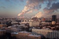 View of the big city from above. Smoking chimneys of boiler rooms on the background of the cityscape