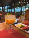 view of a big glass with litchi juice and fruits plate Royalty Free Stock Photo