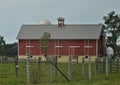 A view of the big red barn and the corrals from the roadway Royalty Free Stock Photo