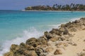 View of big rocks protecting sandy coastline. Turquoise water of Atlantic Ocean. Royalty Free Stock Photo