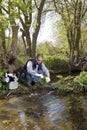 View of a Biologist take a sample in a river. Royalty Free Stock Photo