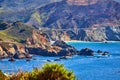 View of Bixby Bridge on west coast from distance surrounded by mountains Royalty Free Stock Photo