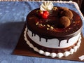 45 view of black forest cake in blue table Royalty Free Stock Photo