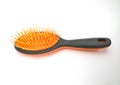 View of black plastic hairbrush with orange bristles isolated on white background. Black rubber massage comb for wet hair. Beauty Royalty Free Stock Photo