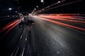 View of black SUV car parking on the road with  traffic light trails. Royalty Free Stock Photo