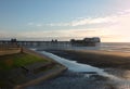 View of blackpool south pier at sunset with the promenade and beach illuminated by evening sunlight Royalty Free Stock Photo