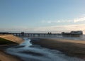 View of blackpool south pier at sunset with the promenade and beach illuminated by evening sunlight Royalty Free Stock Photo