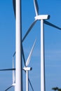 View of blades, rotor hub and nacelle of three wind mills with part of their towers. Royalty Free Stock Photo