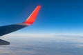 View of the blue clear sky from the height of flight above the clouds from the window of the plane in the bright sun Royalty Free Stock Photo