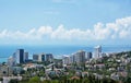 View of blue coast of Black Sea in Sochi with houses under summer blue sky. Sochi, Russia, 2019/06/24