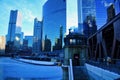 View of a blue and frigid winter morning in Chicago with a frozen river alongside an elevated bridge and bridgehouse.