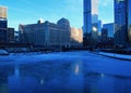 View of a blue and frigid winter morning in Chicago with reflections on a frozen Chicago River.