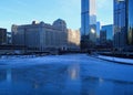 View of a blue and frigid winter morning in Chicago with reflections on a frozen Chicago River.