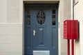 A view of a blue front door and a red mailbox in an apartment building Royalty Free Stock Photo