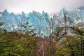 Front view of Perito Moreno Glacier, in El Calafate, Argentina, against a grey and cloudy sky.