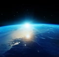 View of blue planet Earth with sun rising from space. Royalty Free Stock Photo