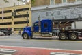 View of a blue semi-truck driving along 34th Street in New York City.