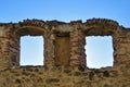 View of blue sky through arched windows of loophole in wall of an ancient fortress. Copy space.