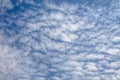 View of a blue sky with a small clouds, different shapes and textured clouds