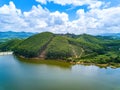 View of blue sky, white clouds and green hills and forest at outdoor reservoir Royalty Free Stock Photo