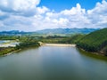 View of blue sky, white clouds and green hills and forest at outdoor reservoir Royalty Free Stock Photo