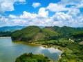 View of blue sky, white clouds and green hills and forest at outdoor reservoir Royalty Free Stock Photo