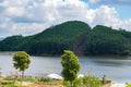 View of blue sky, white clouds and green hills and forest at outdoor reservoir Royalty Free Stock Photo