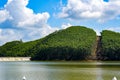 View of blue sky, white clouds and green hills and forest at outdoor reservoir Royalty Free Stock Photo