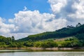 View of blue sky, white clouds and green hills and forest at outdoor reservoir Royalty Free Stock Photo